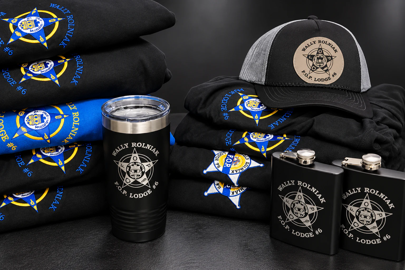 Custom printed shirts and a hoodie arranged for a product showcase